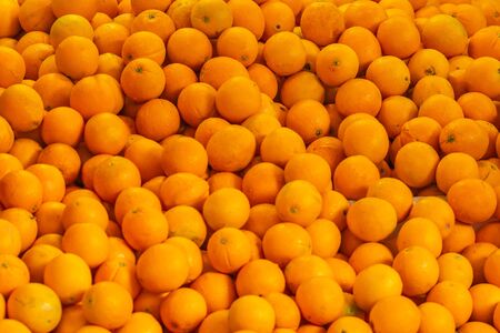 Abstract pattern background of pile sweet Navel orange in supermarket (Citrus x sinensis ,Citrus aurantium) which is hybrid fruit between pomelo and mandarin orange as agricultural productsの写真素材