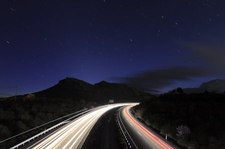 traffic at night in a motorway under the stars 