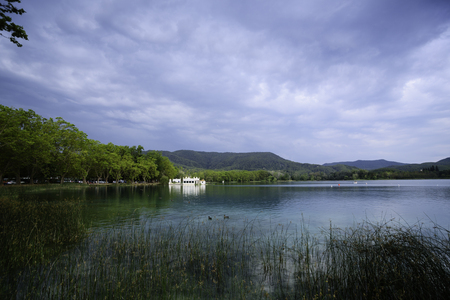 Lake Banyoles is the largest lake in Catalonia, Tourists enjoy the good weather and relax for boating and wooded paths.の写真素材