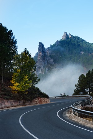 Road near Riopar, Albacete, Spain, with fog in the autumnal landscapeの写真素材