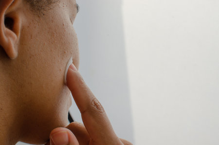 Gentle hands gently applying face cream, moisturizing the skin with care and affection. Self-care routine for a radiant face.の写真素材