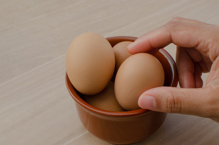 Featured fresh brown chicken eggs perfectly laid out on the table in a bowl.の写真素材