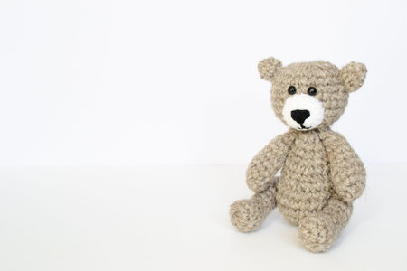 Crochet gray bear on white background. Crocheted toy. crocheted bear
