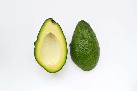 Pitted avocado halves isolated on white background. View from aboveの写真素材