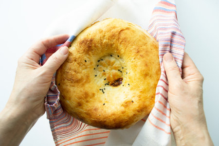 Armenian pita in womens hands. Fresh white flatbread close-up. The national Armenian bread.の写真素材