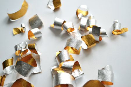 Gold banner with confetti on gray background.の写真素材