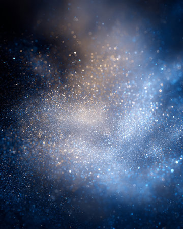 Blue and gold glitter particles on dark background, sparkling festive dust wave, abstract luxury textureの素材