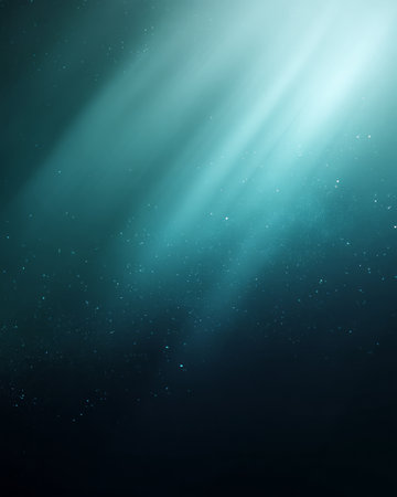 Turquoise light rays shining through mist with glowing particles on dark backgroundの素材