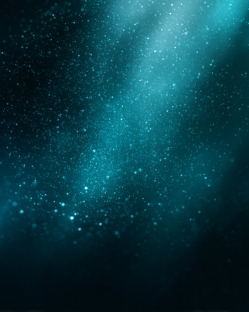 Shimmering turquoise particles with glowing light beams in cosmic abstract backgroundの素材