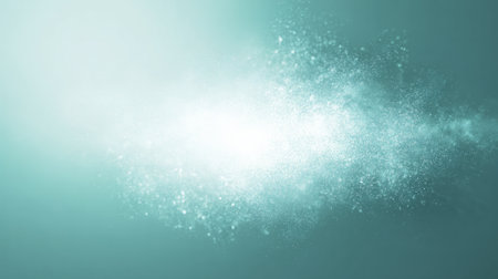 Bright turquoise dust cloud with glowing particles on soft gradient backgroundの素材