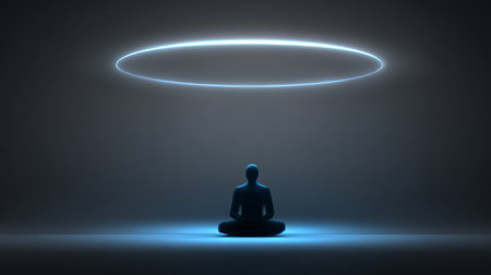 Minimal meditating silhouette under glowing blue energy ring on dark futuristic backgroundの素材