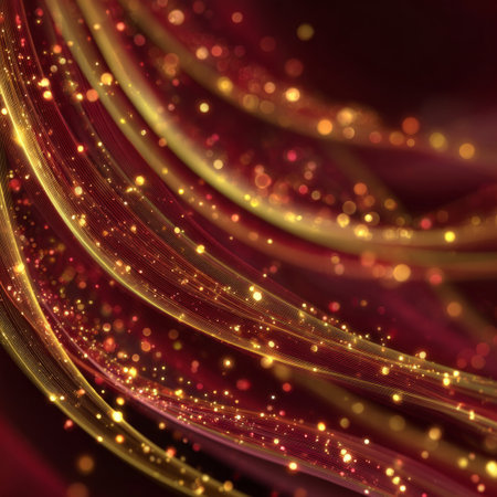Golden flowing light trails on deep red background with sparkling bokeh and vibrant motionの素材