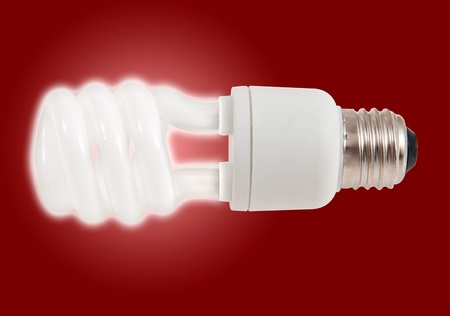New style light bulb glowing on redの写真素材
