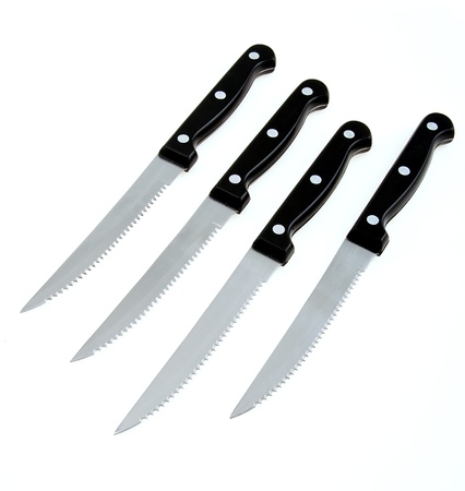 Stainless steel steak knives on whiteの写真素材