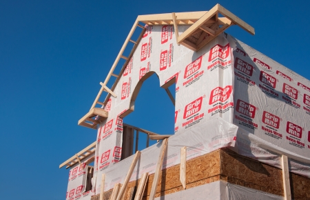 SUBURBAN DETROIT HOUSING CONSTRUCTION- SUMMER 2013 Outer rough frame of new home constrution lumber and workersのeditorial素材