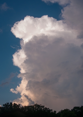 Storm clouds rolling past clear skiesの写真素材