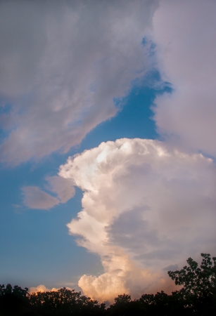Storm clouds rolling past clear skiesの写真素材