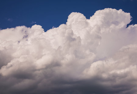 Storm clouds rolling past clear skies