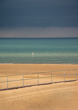 Storm clouds over lake Michigan beachの写真素材
