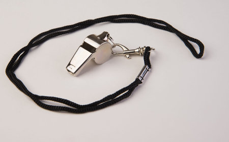 Coaches chrome sports whistle on a rope