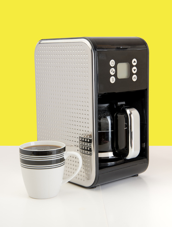 Fresh Coffee pouring into fancy cup on table topの写真素材