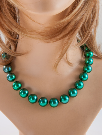 Green necklace on neck of model jewelryの写真素材