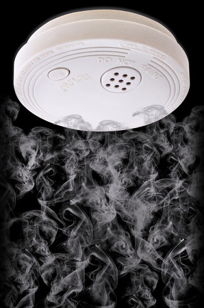 Smoke plumes drifting up to set off warning deviceの写真素材