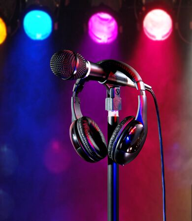 Live on colorful stage lights singers microphone and headsetの写真素材