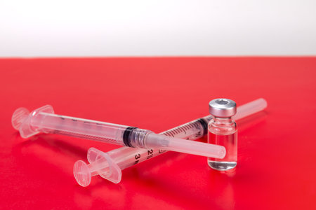 Red warning for covid vaccine protection meds and syringeの写真素材