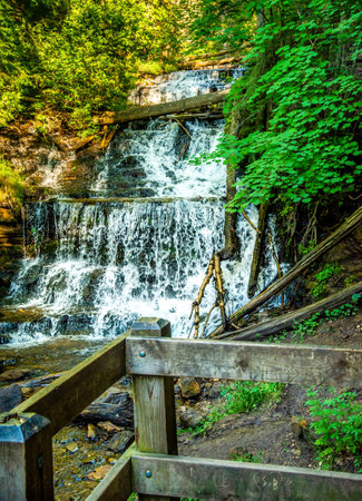 Viewing deck for watching Wagner Falls cascading down wagner river creekの写真素材