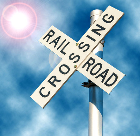 Railroad crossing sign for trains coming across roadwayの写真素材