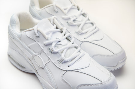 White gym shoes showing detailed design and texture on a clean studio background.の写真素材