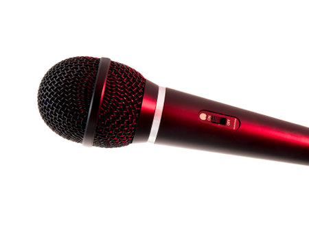 A sleek red handheld microphone captured with a white background. Highlighting the on/off switch and elegant design, this image is ideal for events, singing, podcasts, and music-related projects.の写真素材