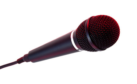 Dynamic microphone highlighting its intricate mesh and bold red and black design, perfect for singing, podcasts, performances, or karaoke, isolated on a white background.の写真素材