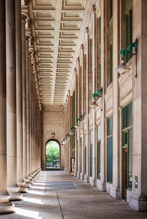 View of a classic architectural colonnade featuring tall pillars and arched passageways, capturing a sense of symmetry, grandeur, and timeless architectural design.の写真素材