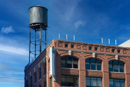 Historic building with water tower in downtown Detroit showcasing urban architecture and skylineの写真素材