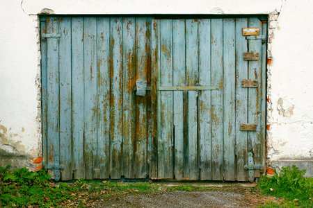 Old painted wooden garage door of blue colorの写真素材