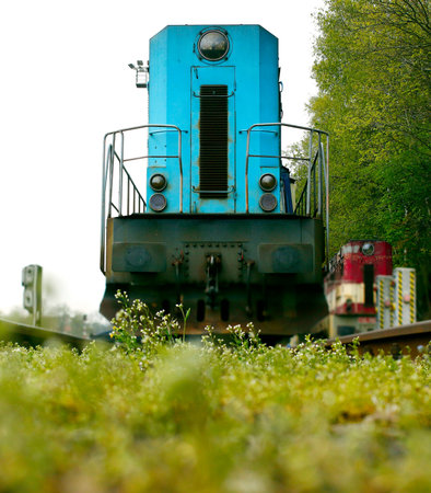 Blue diesel locomotive standing on rails