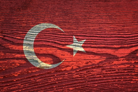The flag of Turkey is painted on a wooden board with a wooden structureの写真素材