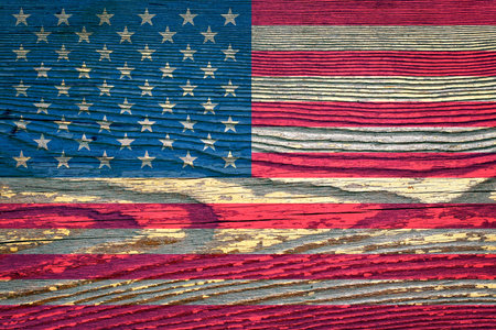 The flag of USA painted on a wooden board with a wooden structureの写真素材