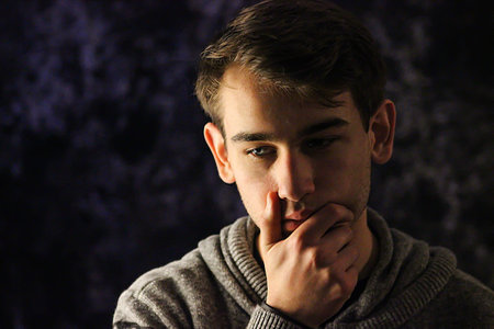 Thinking Teenager Posing With Hand Cupping Chin