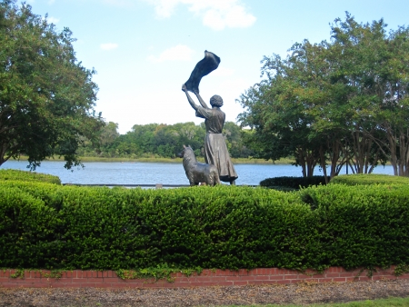 River Street, Savannah, GA Waving Girl statue with collie dogの写真素材