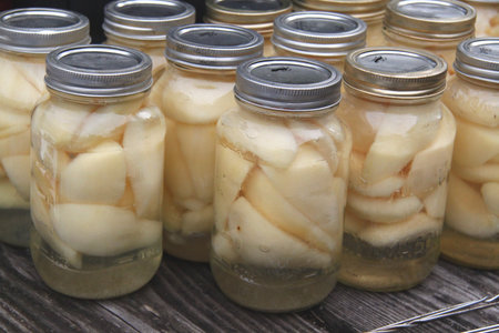 rows of jars of canned pearsの写真素材