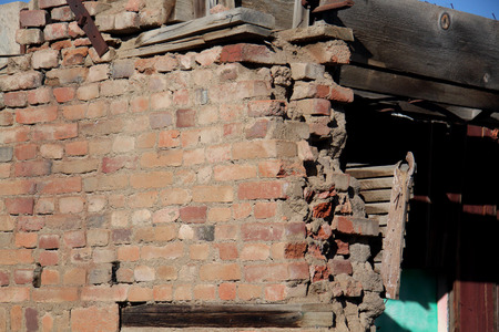 brick wall collapsing and falling apartの写真素材