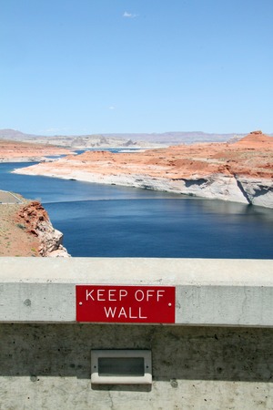 keep off wall sign on a damの写真素材