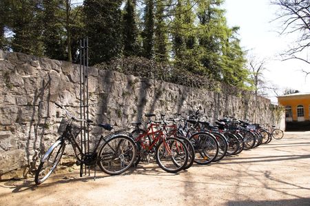 there is the parking for bicycles near the wall in the parkの写真素材