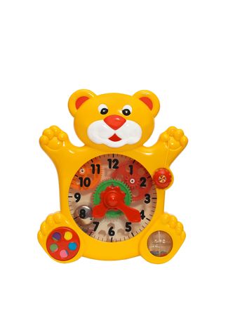there is the toy clock. the clock is very interesting and useful for children. they can play and learn the time and numbers.  it has a form of puma or leon. the clock face is transparent. you can see inside gear wheels and bell.の写真素材