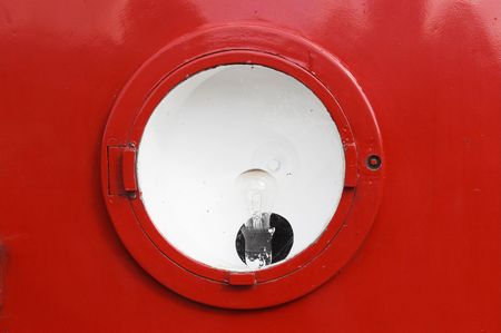 old headlight is on red, bulls-eyeの写真素材