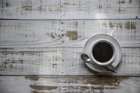 White coffee cup top view on wooden  background with copy spaceの写真素材