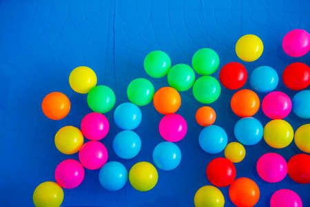 Colorful plastic balls on rubber childrens' pool full of water.の写真素材
